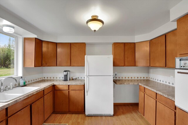2111 W Mason Rd, Deer Park, WA 99006 - kitchen with white appliances, a sink, backsplash, and light wood-style floors