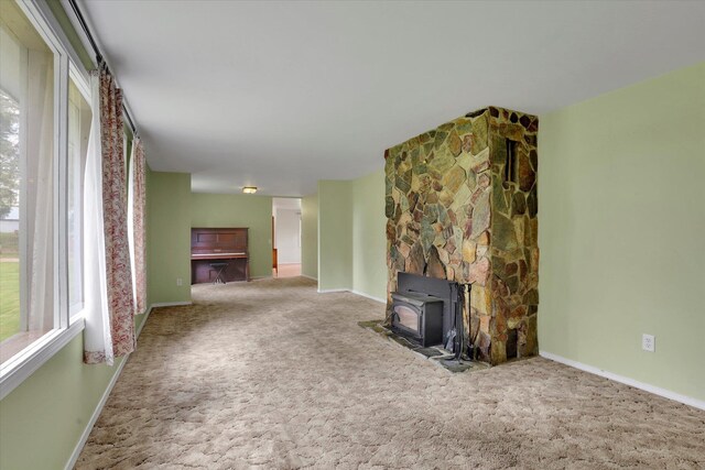 2111 W Mason Rd, Deer Park, WA 99006 - unfurnished living room with a wood stove, carpet floors, and baseboards
