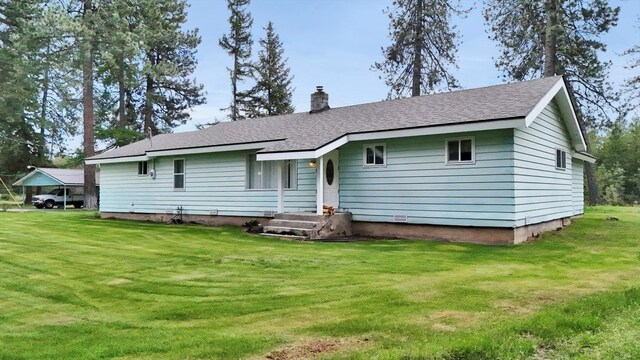 2111 W Mason Rd, Deer Park, WA 99006 - rear view of house with a yard, a chimney, and a shingled roof