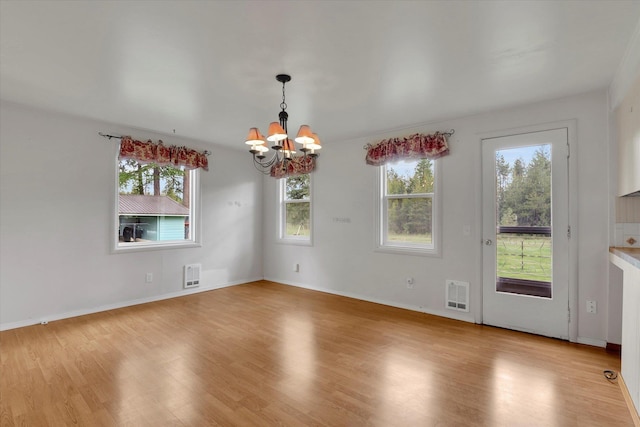 2111 W Mason Rd, Deer Park, WA 99006 - unfurnished dining area featuring a chandelier, healthy amount of natural light, and light wood-style floors