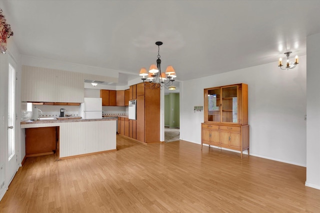 2111 W Mason Rd, Deer Park, WA 99006 - kitchen with a chandelier, white appliances, open floor plan, and a peninsula