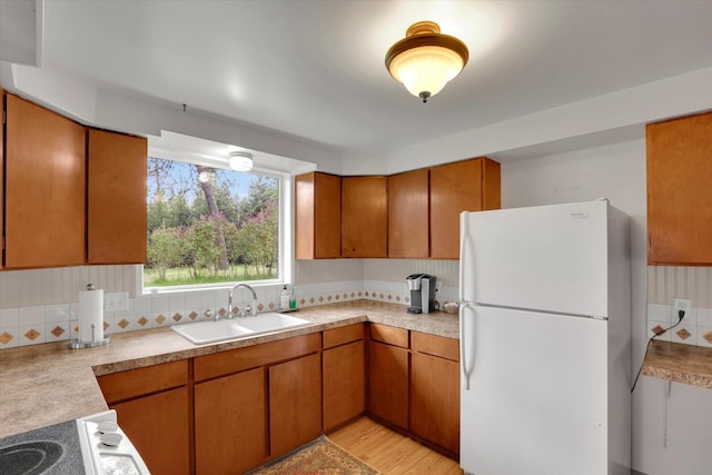 2111 W Mason Rd, Deer Park, WA 99006 - kitchen featuring freestanding refrigerator, a sink, light countertops, and brown cabinetry