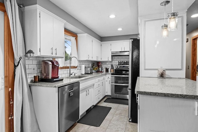 6721 N Washington St, Spokane, WA 99208 - kitchen with appliances with stainless steel finishes, white cabinetry, decorative backsplash, under cabinet range hood, and light tile patterned floors