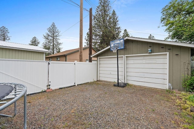 6721 N Washington St, Spokane, WA 99208 - view of yard featuring an outbuilding, a garage, and a trampoline