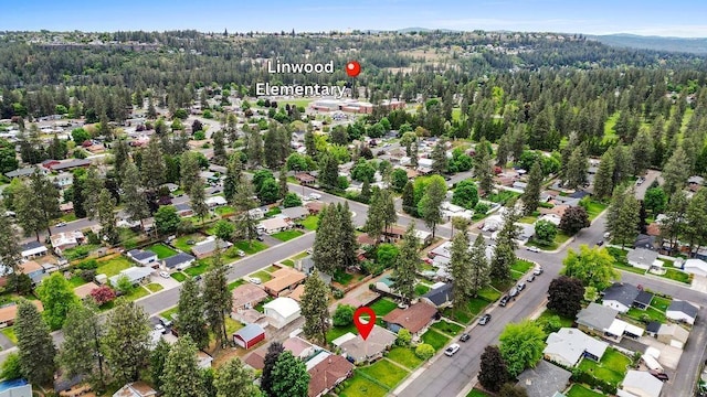 6721 N Washington St, Spokane, WA 99208 - aerial overview of property's location with a forest and nearby suburban area