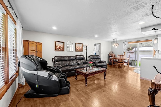 6721 N Washington St, Spokane, WA 99208 - living area featuring wood finished floors, recessed lighting, and a textured ceiling