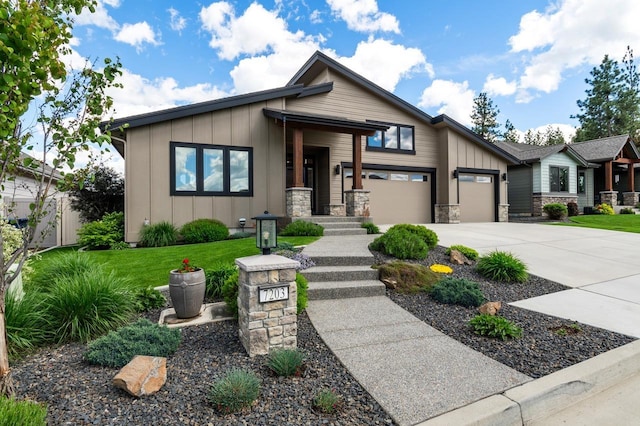 7203 S Tangle Heights Dr, Spokane, WA 99224 - view of front of house with board and batten siding, driveway, a garage, and stone siding