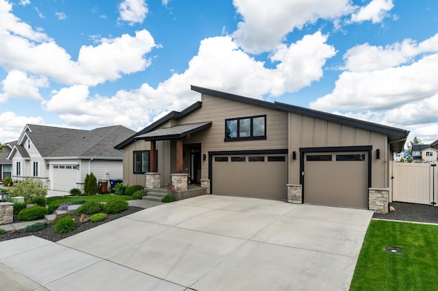 7203 S Tangle Heights Dr, Spokane, WA 99224 - view of front facade featuring stone siding, board and batten siding, concrete driveway, and an attached garage