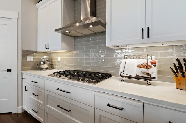 7203 S Tangle Heights Dr, Spokane, WA 99224 - kitchen with wall chimney range hood, stainless steel gas cooktop, white cabinets, decorative backsplash, and light stone countertops
