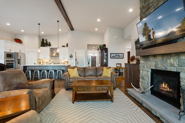 7203 S Tangle Heights Dr, Spokane, WA 99224 - living room featuring wood finished floors, beamed ceiling, high vaulted ceiling, a fireplace, and recessed lighting