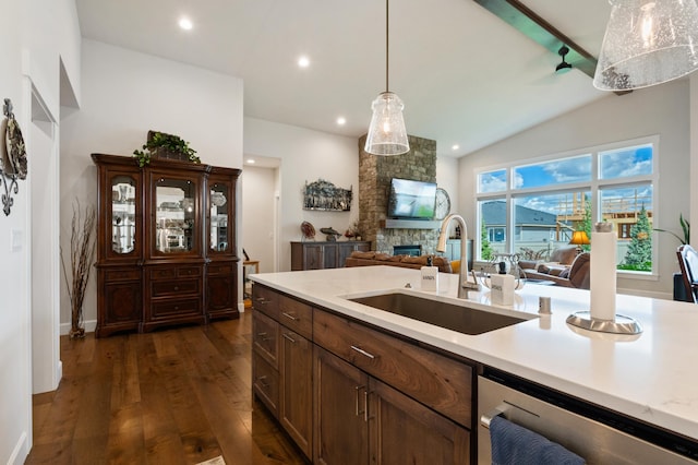 7203 S Tangle Heights Dr, Spokane, WA 99224 - kitchen featuring a sink, lofted ceiling, light countertops, dark wood-style flooring, and a fireplace