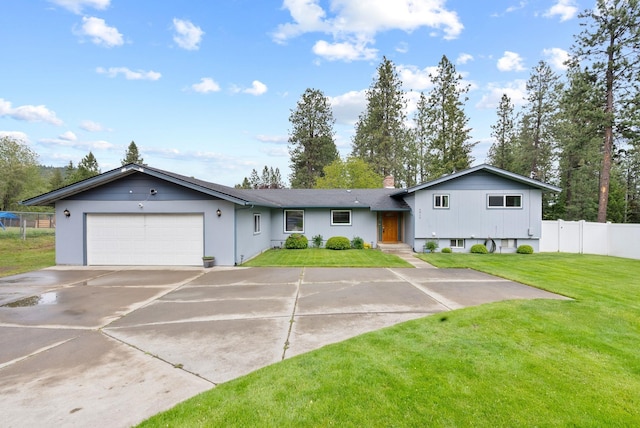 9815 E 44th Ave, Spokane Valley, WA 99206 - tri-level home with a garage, concrete driveway, and a chimney