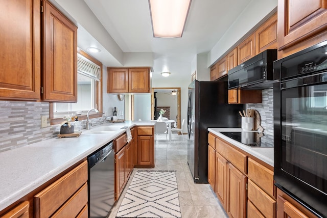 9815 E 44th Ave, Spokane Valley, WA 99206 - kitchen featuring black appliances, tasteful backsplash, and light countertops