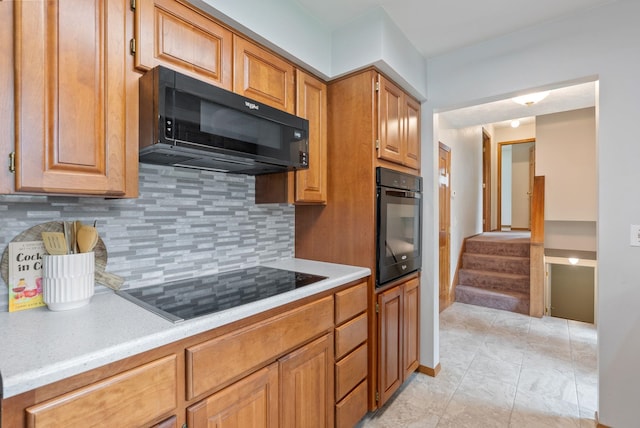 9815 E 44th Ave, Spokane Valley, WA 99206 - kitchen featuring black appliances, light countertops, tasteful backsplash, and brown cabinetry