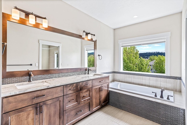 4305 S Bernson Ln, Spokane, WA 99223 - bathroom with double vanity, a relaxing tiled tub, and tile patterned flooring