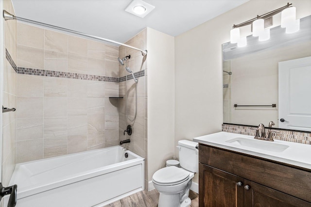 4305 S Bernson Ln, Spokane, WA 99223 - full bath featuring shower / tub combination, toilet, vanity, wood finished floors, and backsplash