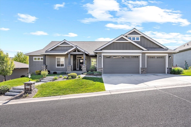 4305 S Bernson Ln, Spokane, WA 99223 - craftsman-style home with a front yard, a garage, driveway, board and batten siding, and stone siding
