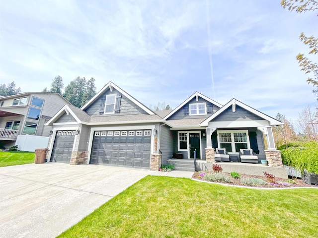 1602 S Canyon Woods Ln, Spokane, WA 99224 - craftsman inspired home with stone siding, covered porch, a garage, a front yard, and driveway