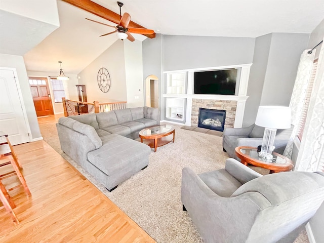 1602 S Canyon Woods Ln, Spokane, WA 99224 - living room with a ceiling fan, light wood-style floors, arched walkways, and a stone fireplace