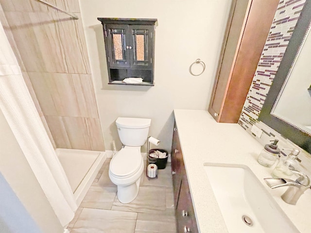 1602 S Canyon Woods Ln, Spokane, WA 99224 - full bathroom featuring toilet, vanity, a tile shower, and tile patterned floors