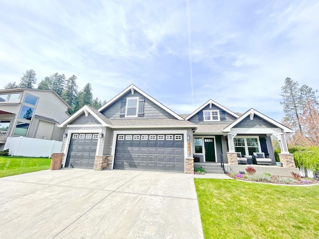 1602 S Canyon Woods Ln, Spokane, WA 99224 - craftsman inspired home with stone siding, a porch, driveway, and a garage