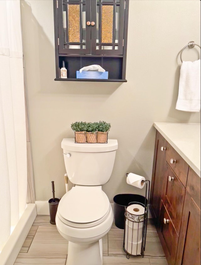 1602 S Canyon Woods Ln, Spokane, WA 99224 - bathroom with toilet, vanity, a shower with curtain, and baseboards