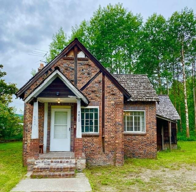 4410 Williams Valley Rd, Clayton, WA 99110 - tudor-style house with brick siding and a chimney