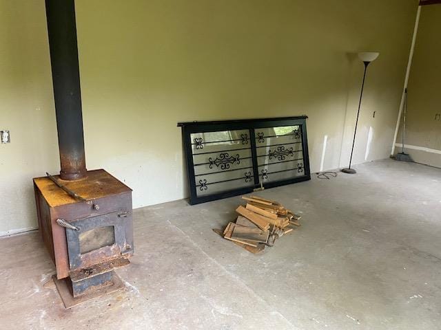 4410 Williams Valley Rd, Clayton, WA 99110 - unfurnished living room featuring a wood stove and concrete floors