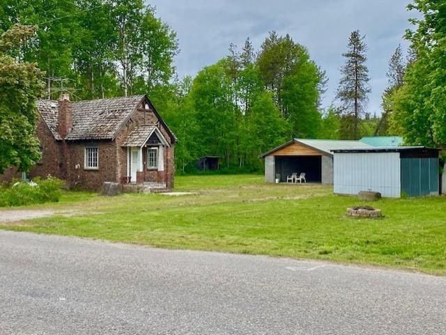 4410 Williams Valley Rd, Clayton, WA 99110 - view of grassy yard featuring a pole building, a detached garage, an outbuilding, and view of scattered trees