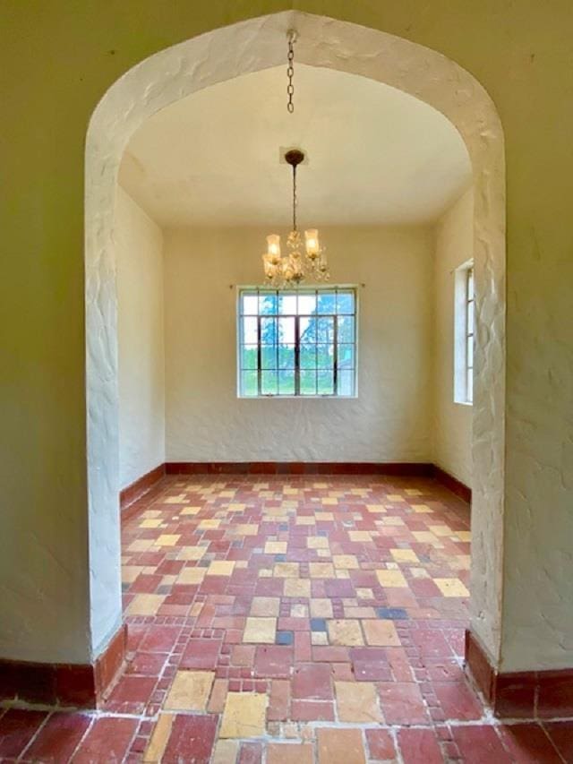 4410 Williams Valley Rd, Clayton, WA 99110 - unfurnished dining area with arched walkways, plenty of natural light, and baseboards