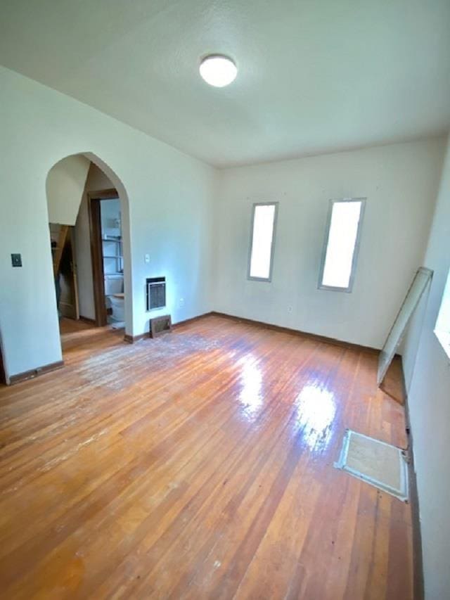 4410 Williams Valley Rd, Clayton, WA 99110 - unfurnished living room with wood-type flooring, arched walkways, heating unit, and baseboards
