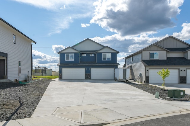 1116 Greenfield Dr, Cheney, WA 99004 - view of front facade featuring board and batten siding, a garage, concrete driveway, cooling unit, and stone siding