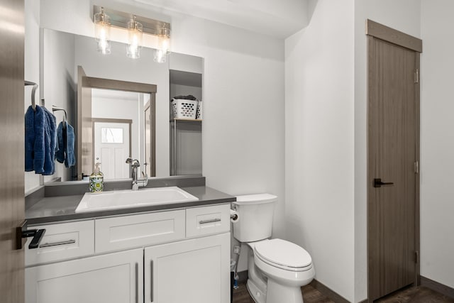 1116 Greenfield Dr, Cheney, WA 99004 - bathroom with vanity, toilet, and wood finished floors