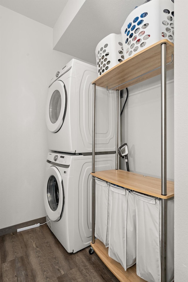 1116 Greenfield Dr, Cheney, WA 99004 - washroom featuring stacked washer / dryer, dark wood-style flooring, and baseboards