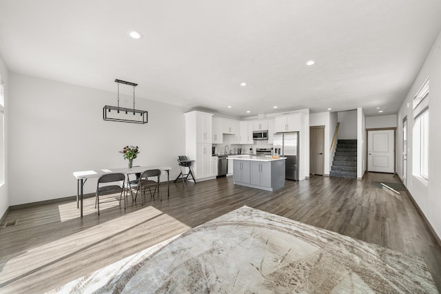 1116 Greenfield Dr, Cheney, WA 99004 - living area featuring dark wood finished floors, stairs, recessed lighting, and baseboards