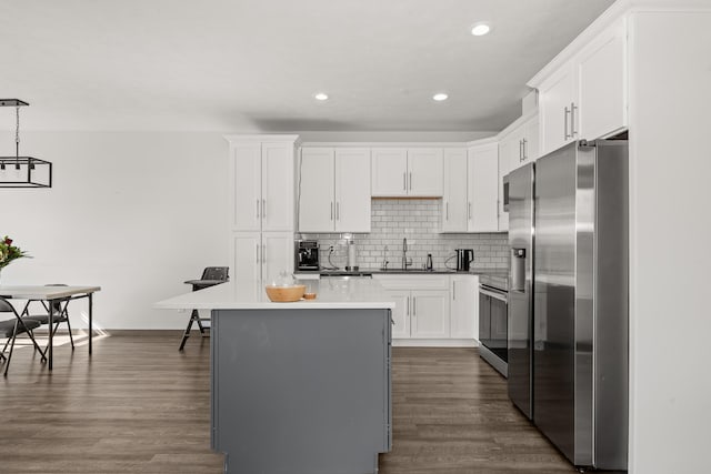 1116 Greenfield Dr, Cheney, WA 99004 - kitchen featuring stainless steel appliances, a sink, a center island, white cabinets, and backsplash