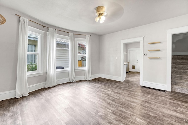 2305 W Sharp Ave, Spokane, WA 99201 - empty room featuring wood finished floors, healthy amount of natural light, ceiling fan, and baseboards