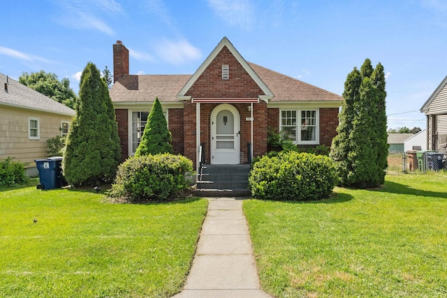 2417 W Euclid Ave, Spokane, WA 99205 - view of front facade featuring a front lawn, a chimney, brick siding, and a shingled roof