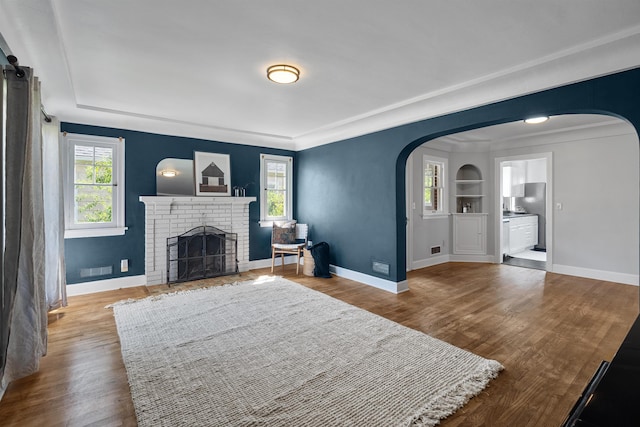 2417 W Euclid Ave, Spokane, WA 99205 - living room featuring arched walkways, wood finished floors, and baseboards