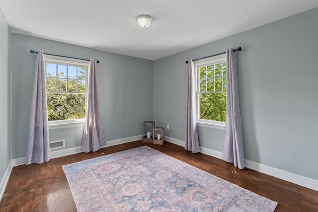 2417 W Euclid Ave, Spokane, WA 99205 - unfurnished room featuring healthy amount of natural light, dark wood finished floors, and baseboards