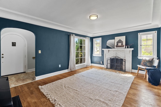 2417 W Euclid Ave, Spokane, WA 99205 - living room with healthy amount of natural light, baseboards, wood finished floors, and a brick fireplace