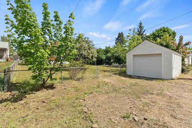 2417 W Euclid Ave, Spokane, WA 99205 - view of yard featuring a garage, dirt driveway, a gate, and an outdoor structure