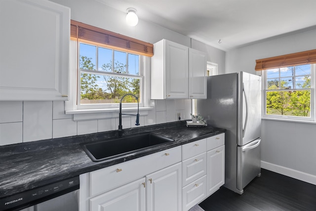2417 W Euclid Ave, Spokane, WA 99205 - kitchen with a sink, appliances with stainless steel finishes, decorative backsplash, baseboards, and white cabinetry