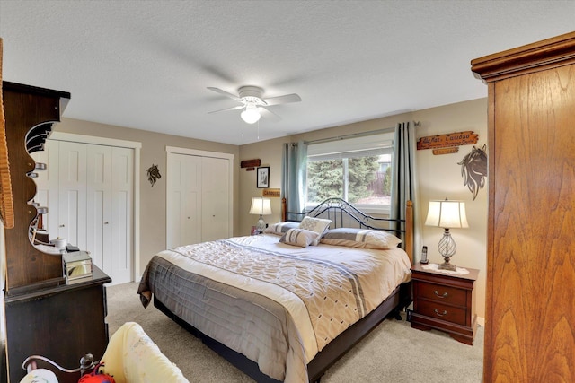 4921 W Londale Ct, Spokane, WA 99208 - bedroom with light colored carpet, two closets, ceiling fan, and a textured ceiling