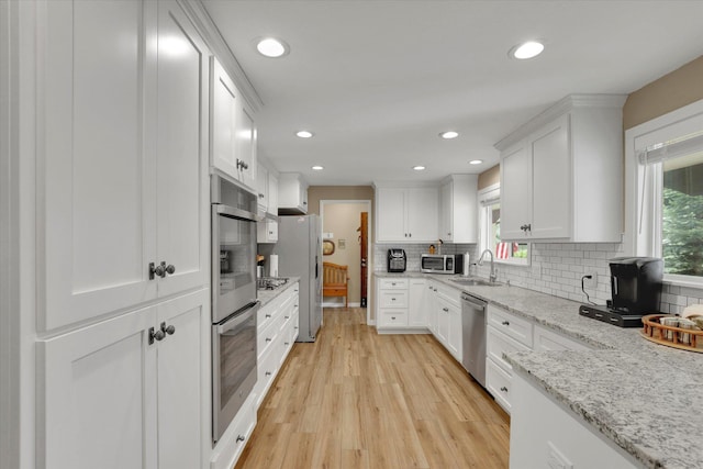 4921 W Londale Ct, Spokane, WA 99208 - kitchen with stainless steel appliances, a sink, healthy amount of natural light, white cabinets, and recessed lighting