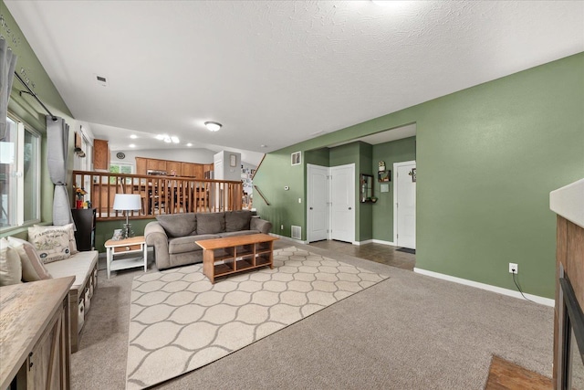 4031 S Bates Rd, Spokane Valley, WA 99206 - living area with dark colored carpet, stairs, and baseboards
