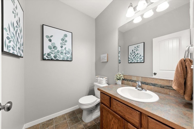 4031 S Bates Rd, Spokane Valley, WA 99206 - bathroom with baseboards, vanity, toilet, backsplash, and tile patterned flooring