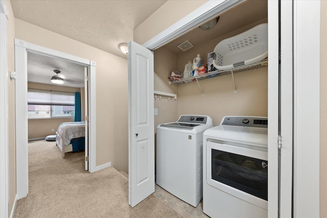 4031 S Bates Rd, Spokane Valley, WA 99206 - laundry room featuring washer and dryer, light carpet, and a textured ceiling