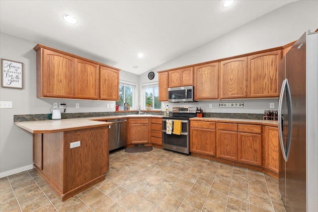 4031 S Bates Rd, Spokane Valley, WA 99206 - kitchen with stainless steel appliances, a peninsula, vaulted ceiling, brown cabinets, and a sink