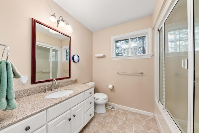 6325 W 48th Ave, Spokane, WA 99224 - bathroom with vanity, toilet, baseboards, and shower / bath combination with glass door